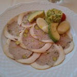 Thinly sliced chicken with an avocado salad and hearts of palm