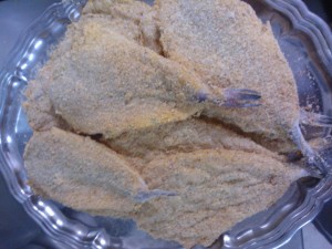 Fish filets coated in flour, an egg mixture, and breadcrumbs