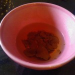 Reconstituting the dried truffles in warm water
