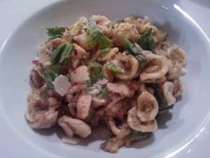 Orechiette with pesto sauce, zucchini, tomatoes, and pine nuts