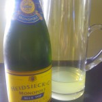A bottle of chilled champagne, alongside a mixture of vodka and Limoncello