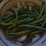 Crisp green beans being shocked in ice water, after being blanched