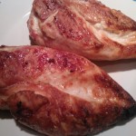 Perfectly tender, grilled chicken breasts resting before being sliced