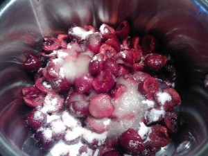 The mixture of fresh cherries, sugar, and lemon juice