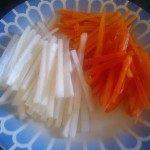 A mix of julienned vegetables: carrots, daikon radish and red pepper
