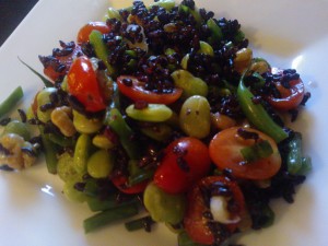 A black rice salad tossed with lima beans, green beans, walnuts & cherry tomatoes.