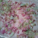 Cooked bacon & leeks spread on the blind-baked crust