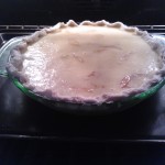 The apple-custard filled pie ready to be baked