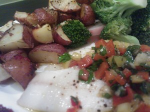 Baked sole served with steamed broccoli and roasted potatoes with rosemary