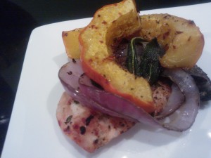 Grilled chicken cutlets topped with roasted squash, grilled onion and fried sage