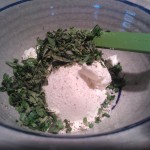 Chopped, fresh herbs being added into the ricotta cheese