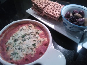 Herbed Baked Ricotta served with multi-grain crackers and a mixture of olives