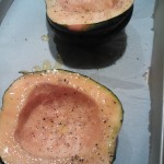 Halved acorn squash ready to be baked