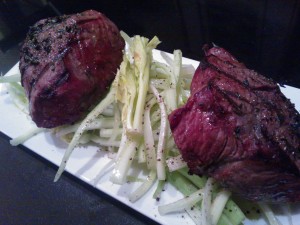 Grilled sirloin filets atop a fresh celery salad