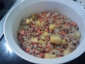 The first layer of sautéed black eyed peas, onions, carrots & celery root