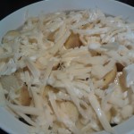 The topping of thinly sliced potatoes covered with Swiss cheese