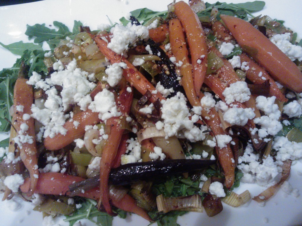 The roasted vegetables served over peppery arugula