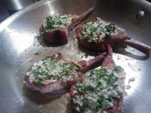 The seared lamb chops topped with mustard & a breadcrumb-parsley mixture, ready to be baked