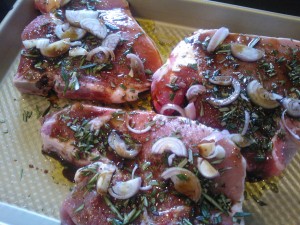 Marinating the pork chops with rosemary, shallots, olive oil and Worcestershire sauce