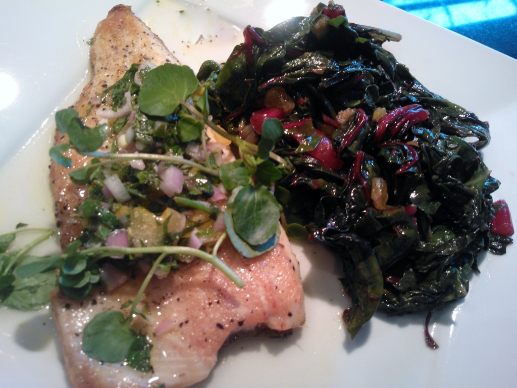 The trout dish served alongside sauteed Swiss chard with golden raisins