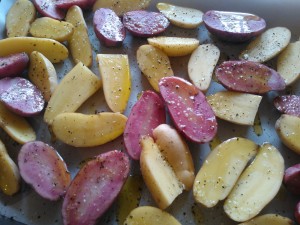 The seasoned potatoes, ready to be roasted