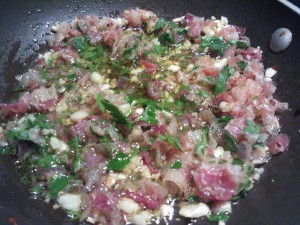 The cooked mixture of olive oil, garlic, crushed red pepper flakes, and cooked pancetta