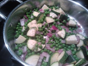 A simple saute of fresh peas, zucchini & red onions