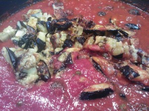Simmering the traditional sauce with an addition of roasted eggplant