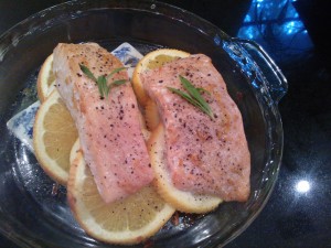 Roasting the marinated salmon on top of sliced oranges and lemons