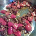 Sauteing the onions, tomato pasta, olives and cherry tomatoes for the ciabatta bread
