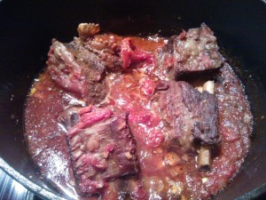 The short ribs cooking in the tomato sauce